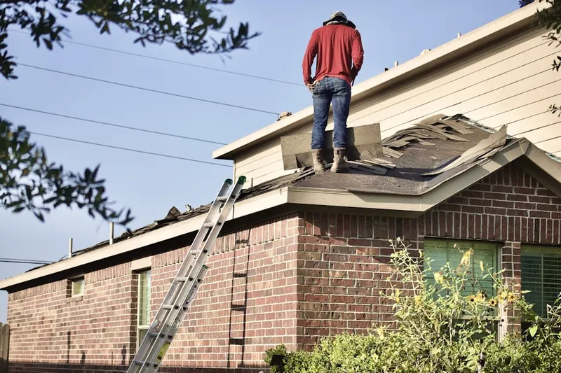 Professional roofer working on a residential roof in Stratmoor